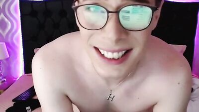 Nerdy twink opens his legs wide and plays with cock and ass