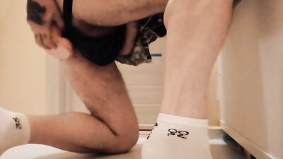 Horny guy is pushing a dildo up his ass in the bathroom