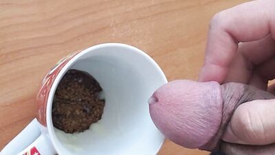 Kinky chum is jerking off and jizzing in a coffee cup