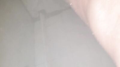 Horny dude is filming his cock under the shower while jerking off