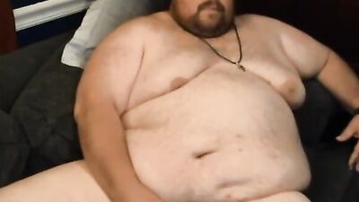 Huge bear is stroking his tiny pecker in front of the camera