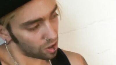 Tattooed bloke is playing with his pecker in the apartment