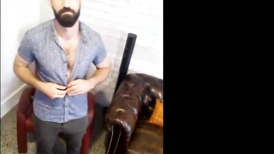 Bearded chap is stripping naked in front of the camera