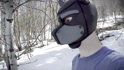Cute dude with a wolf mask films himself talking outdoors