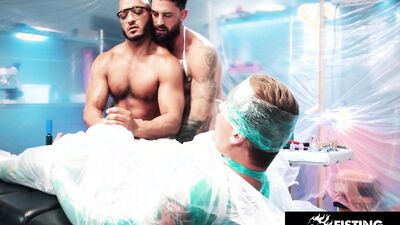 Two exotic hunks tape the guy to a table to toy with him