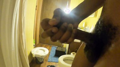 Naughty black dude takes a shower and strokes his cock