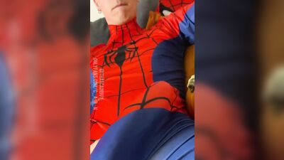 Naughty young dude in a Spiderman costume strokes his dick