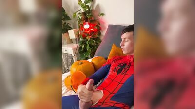 Naughty young dude in a Spiderman costume strokes his dick