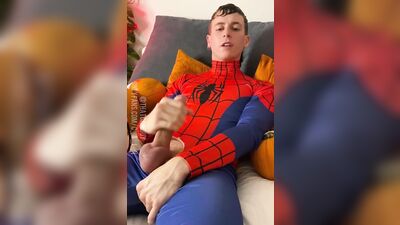 Naughty young dude in a Spiderman costume strokes his dick