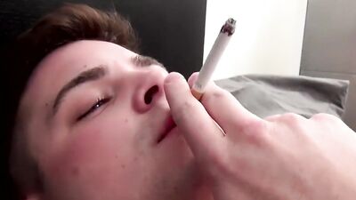 Young guy takes his clothes off and masturbates while smoking
