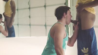 Sporty jocks in athletic outfits fuck in a threesome after oral