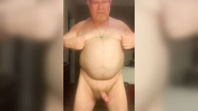 Chubby older guy with glasses strips and strokes his cock
