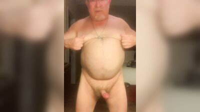 Chubby older guy with glasses strips and strokes his cock