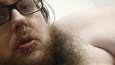 Chubby dude with beard and glasses plays with his cute cock