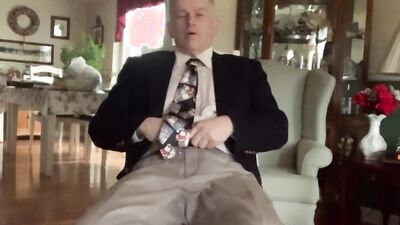 Elegant mature guy in a suit takes his pants off and masturbates