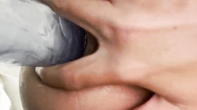 Lovely twink rides a big dildo while stroking his cock