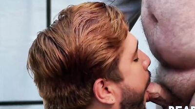 Cute guy on his knees sucks a chubby dude off