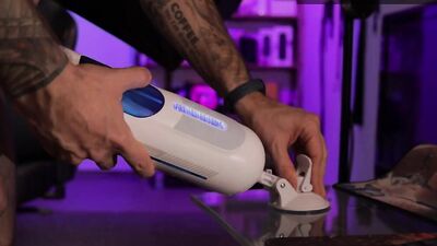 Tattooed guy reviews an automatic masturbator and uses it on his shaved cock