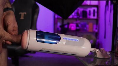 Tattooed guy reviews an automatic masturbator and uses it on his shaved cock