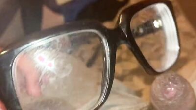 Perverted dude jerks off and cums on his thick glasses