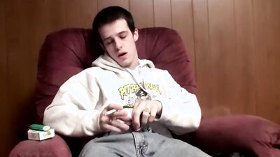 Twink strips naked and smokes while stroking his big cock