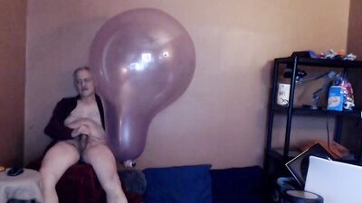 Kinky mature guy blows a balloon up and fucks it
