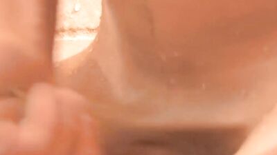 Slender twink strokes his hard cock while taking a shower