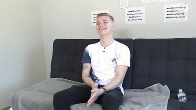 Gorgeous young blonde twink strips naked and strokes his cock