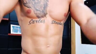Bald and muscular dude with sexy tattoos drills his ass with a dildo