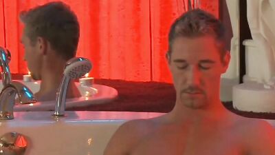 Attractive stud with a monster cock relaxes in a bath and jerks off