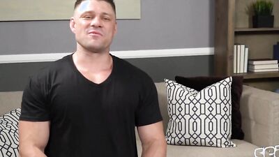 Buff hunk uses both hands to tug on his cock