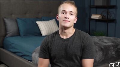 Handsome young guy pulls his cock out and jerks off