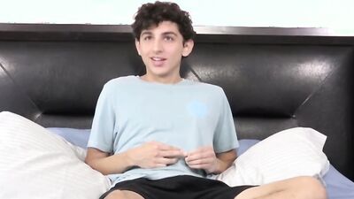 Twink strips naked after an interview and jerks off solo