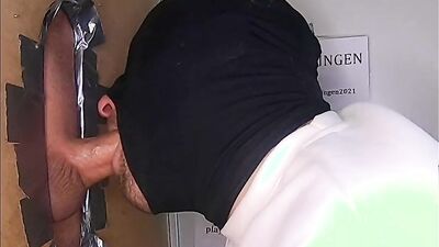Masked gay guy drools on a huge dick in a gloryhole