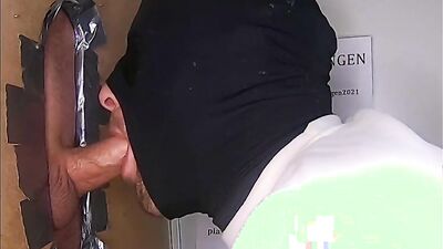 Masked gay guy drools on a huge dick in a gloryhole