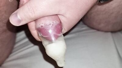 Naughty amateur jerks off and cums multiple times in a condom