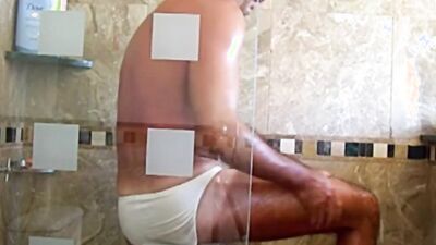 Hot hunk fondles his body in the shower and jerks off