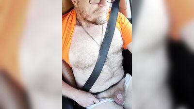 Hairy hunk with sexy glasses jerks off in a car