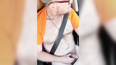 Hairy hunk with sexy glasses jerks off in a car
