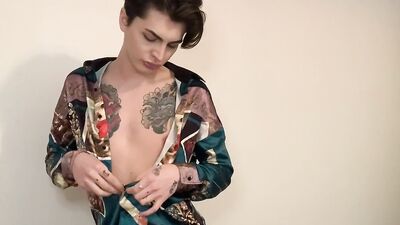Slender twink with sexy tattoos strips and jerks off solo