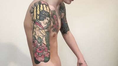 Slender twink with sexy tattoos strips and jerks off solo
