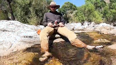 Horny dude goes to a creek in nature to jerk off