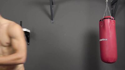 Sporty guy strips and shows his chiseled body in the gym