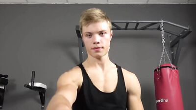 Sporty guy strips and shows his chiseled body in the gym