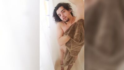 Lovely twink with long hair jerks off in the shower