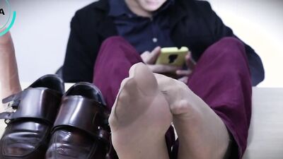 Sexy office worker in an elegant outfit teases a dildo with his feet