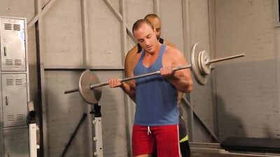 Sporty white stud lifts weights in the gym before a hunk fucks him