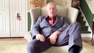 Elegant mature guy in a sexy suit and tie jerks off