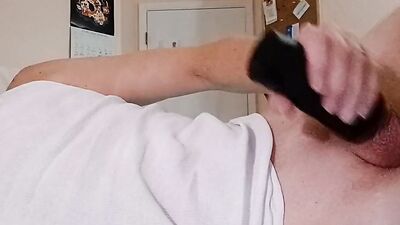 Older guy with a beard and glasses uses a fleshlight