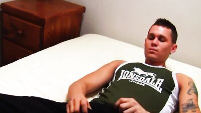 Horny jock tugs on his cock and fucks a fleshlight